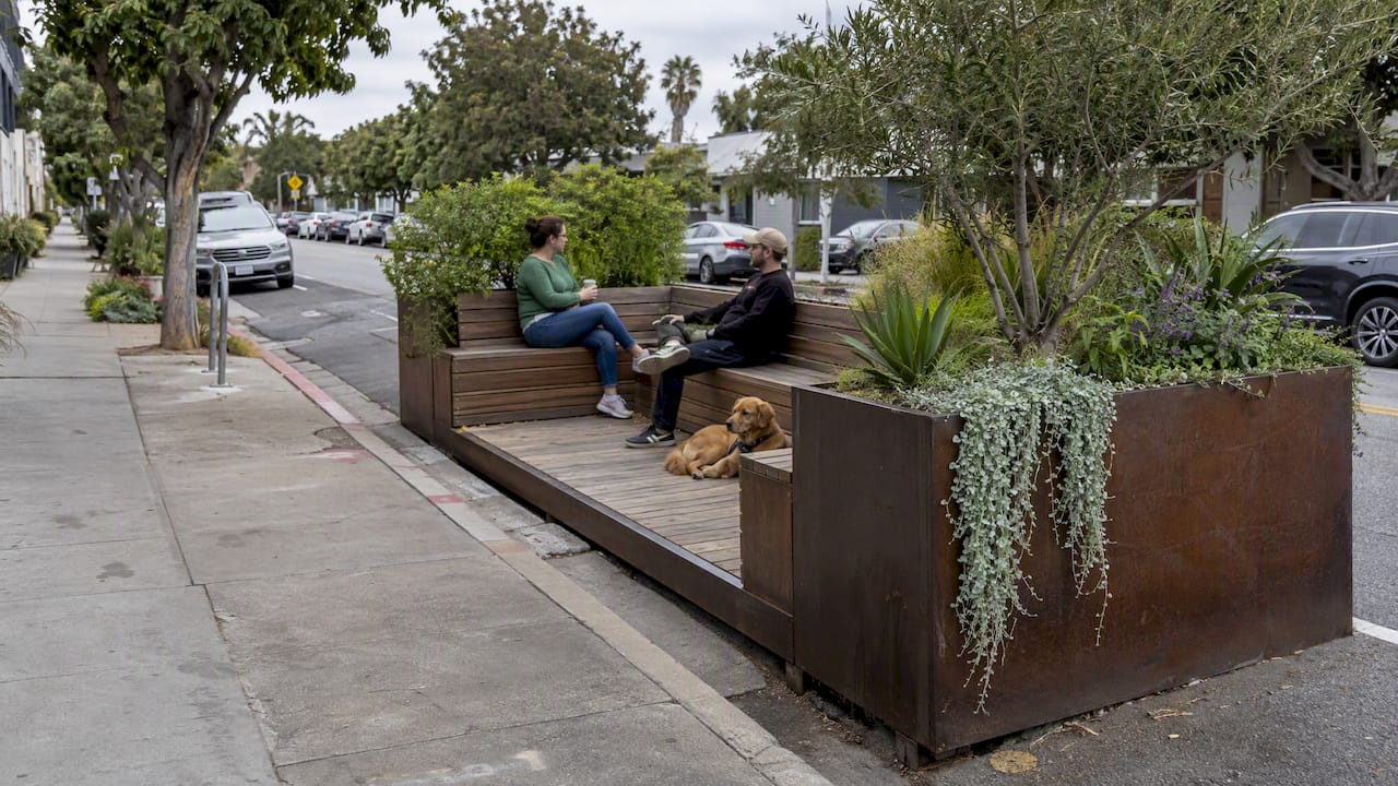 Curbside parklet with seating and planted edges