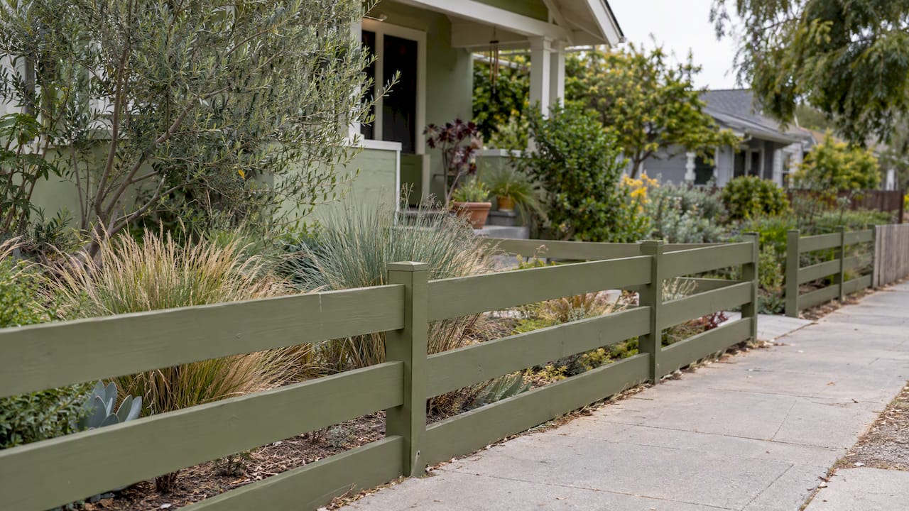 Low front-yard fence beside drought-tolerant planting